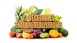 A vibrant assortment of fresh fruits and vegetables including broccoli, carrots, tomatoes, cucumbers, lettuce, grapes, pineapples, oranges, and kiwis, arranged in and around a wicker basket on a white background.