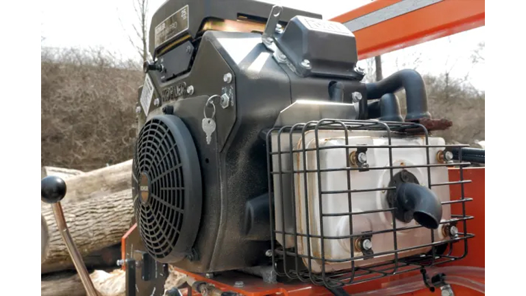 Close-up of the engine of an orange Wood-Mizer LT15 WIDE Portable Sawmill