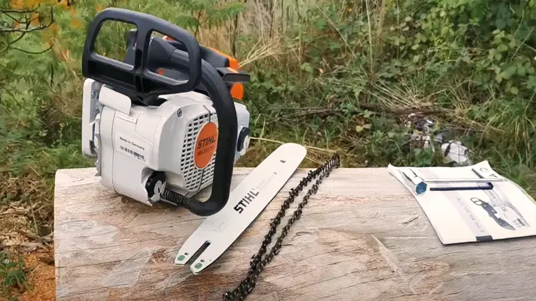 Disassembled Stihl MS 201 TC-M chainsaw with parts on a wooden surface outdoors