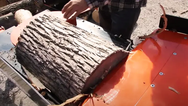 person using a Wood-Mizer FS300 Log Splitter to split a large log