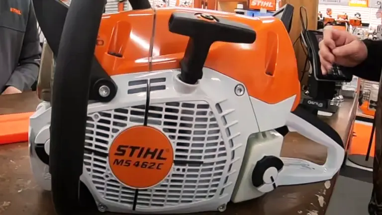 Stihl MS 462 C-M chainsaw with an orange and white body, placed on a table in a workshop