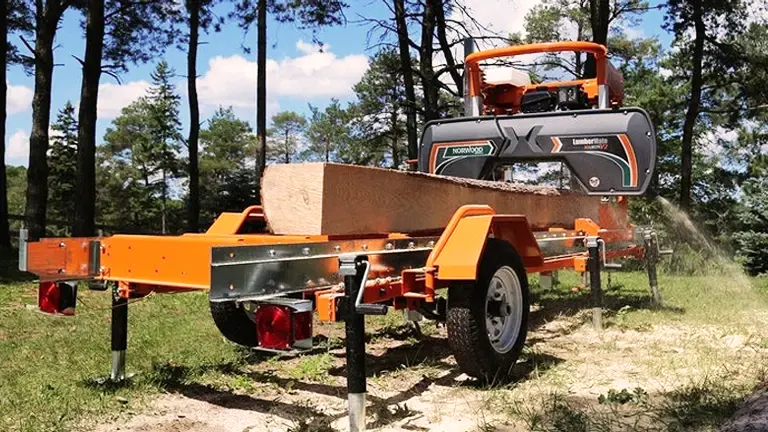 A photo of a Norwood LumberPro HD36V2 portable sawmill in a wooded area.
