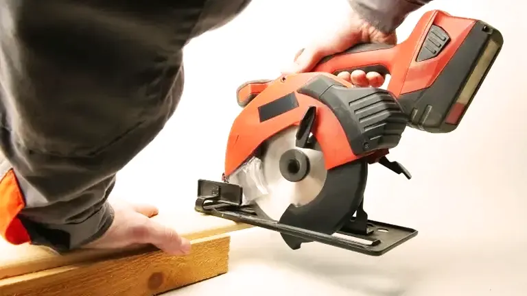 Person cutting wood with a circular saw.