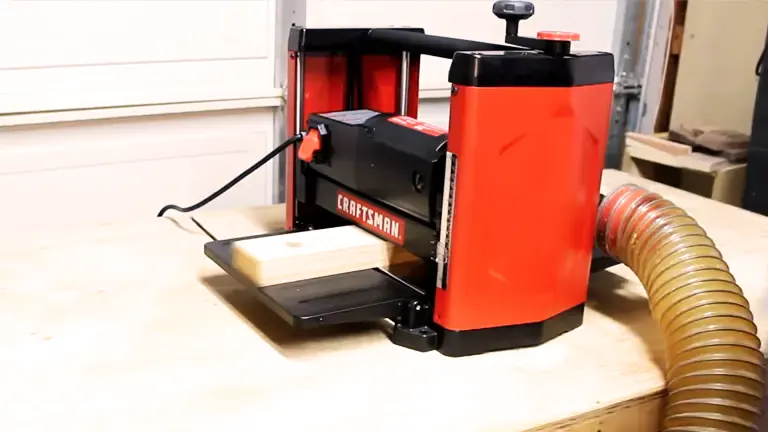 CRAFTSMAN Benchtop Planer with visible yellow roller in a workshop setting.