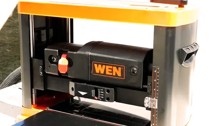 Orange and black WEN 6552T Benchtop Planer with depth adjustment handle and dust collection port