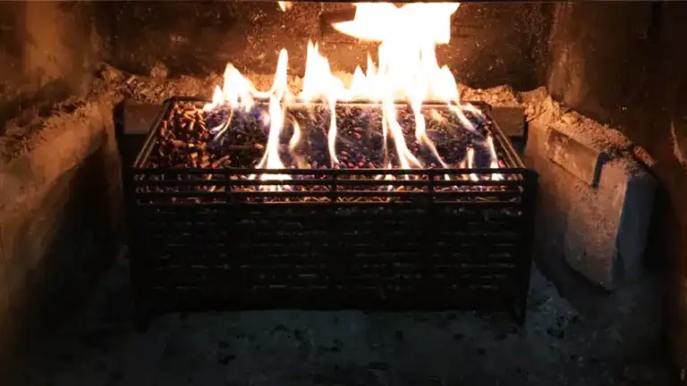 Fire burning pellets in wood stove.