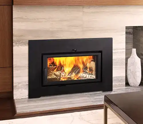 Modern Regency CI2700 wood fireplace insert with a black frame and visible burning logs through the glass.
