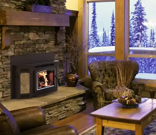 Iron Strike Montlake 300 wood burning insert in a stone fireplace with mountain view.