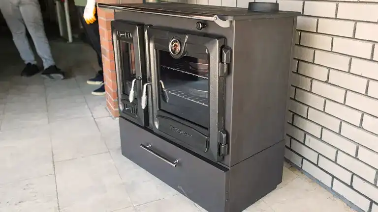 https://forestry.com/wp/wp-content/uploads/2023/10/Multifunctional-Cast-Iron-Wood-Burning-Stove-with-Oven-for-Tiny-Houses-and-Farmhouses-Review-10.webp