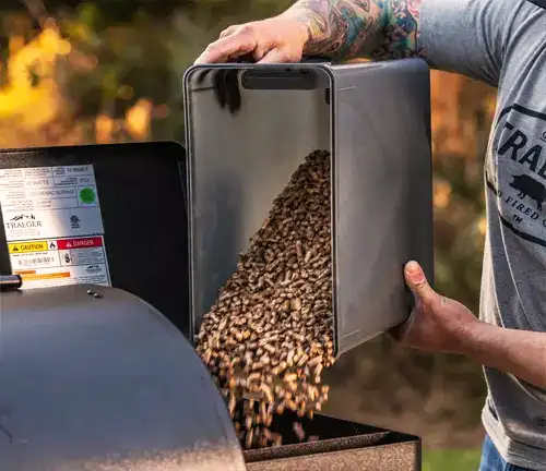 Pouring Wood Pellets in Wood Pellet Stove