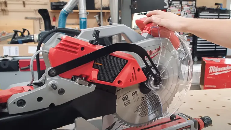 Red Milwaukee 6955-20 12” Dual-Bevel Sliding Compound Miter Saw in use in a workshop setting
