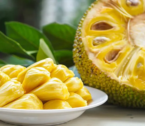 Sliced jackfruit with a plate of yellow jackfruit pieces in the foreground