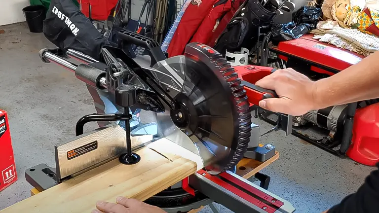 CRAFTSMAN CMXEMAX69434505 12" Single Bevel Sliding Compound Corded Miter Saw in use on a wooden plank