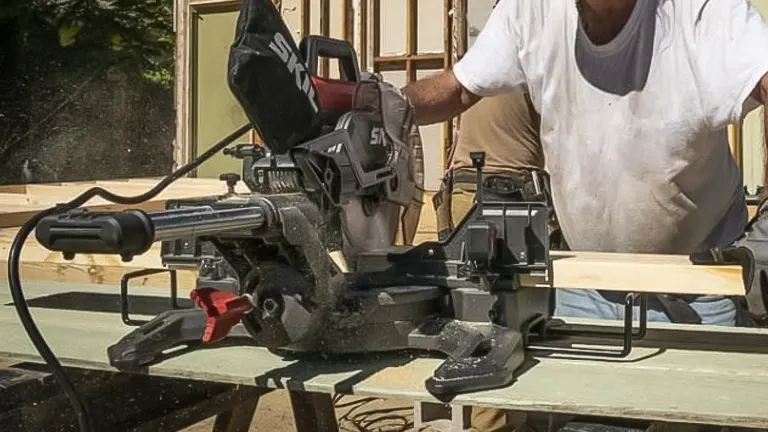 Person using Skil MS6305-00 10” Dual Bevel Sliding Compound Miter Saw on a wooden surface