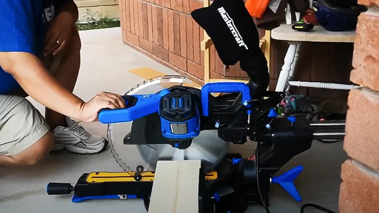 Person using a Mastercraft ZP15 10” Single-Bevel Sliding Compound Miter Saw with Laser on a wooden plank