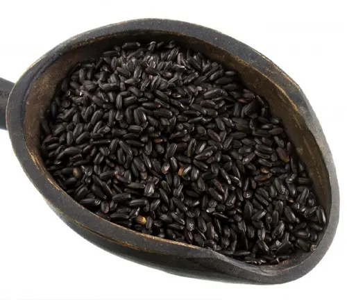 Close-up of cooked black rice in a cast iron skillet.