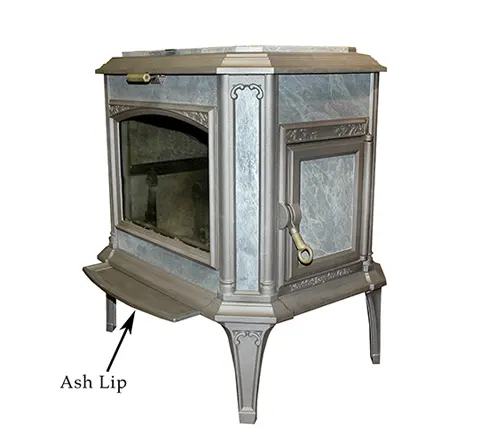 Antique gray and white wood stove with an ash lip and ornate details.