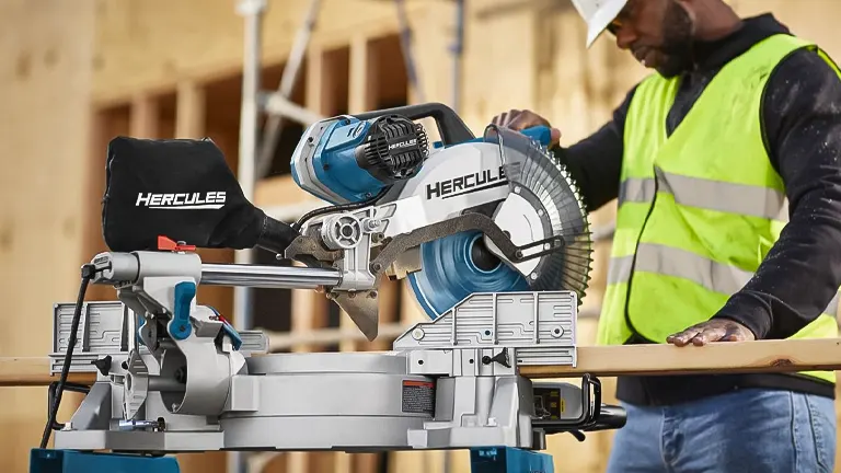 Hercules HE74 12" Dual-Bevel Sliding Compound Miter Saw with Precision LED Shadow Guide on a workbench in a construction site