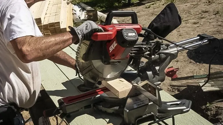 Person using Skil MS6305-00 10” Dual Bevel Sliding Compound Miter Saw at a construction site