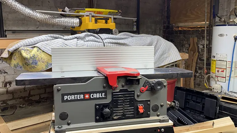 Porter Cable wood jointer on a workbench in a workshop.