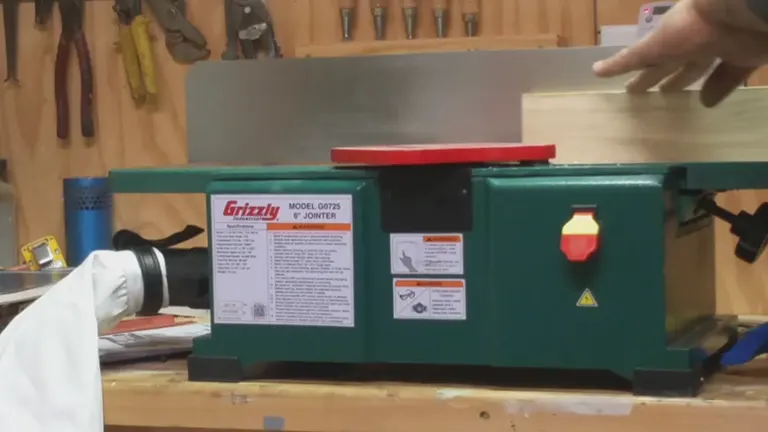 Green Grizzly wood jointer in use in a workshop.