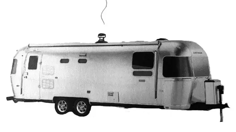 Black and white image of an RV with roof-ready wood stove kit.