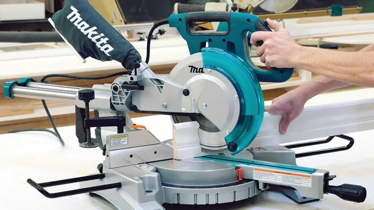 Teal and silver Makita LS1018 10” Dual Slide Compound Miter Saw in use in a workshop