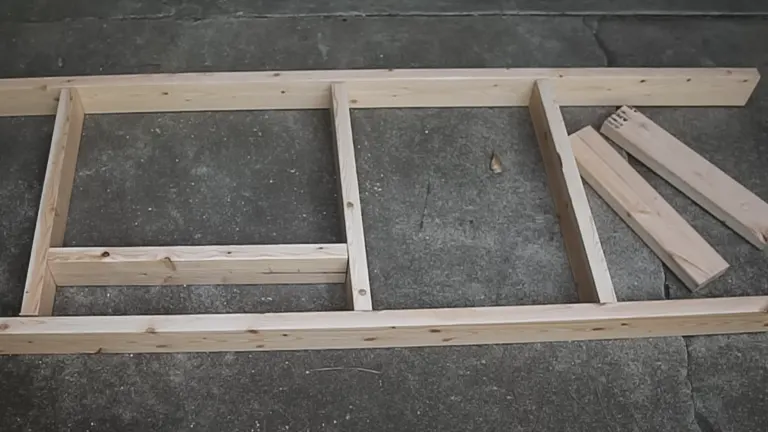 Incomplete wooden frame for a miter saw station on a concrete floor