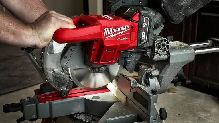 A Milwaukee M18 FUEL™ 12” Dual-Bevel Sliding Compound Miter Saw being used to cut a piece of wood