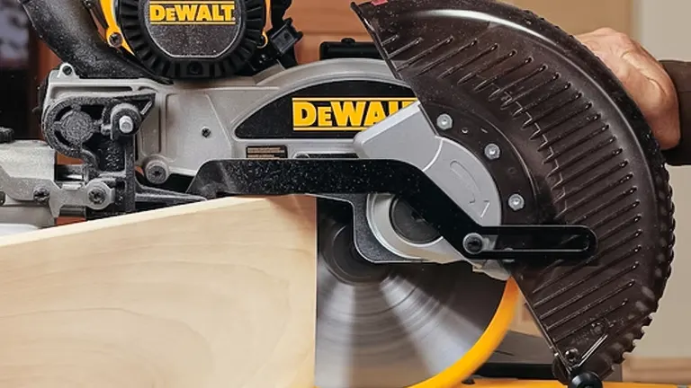 DeWalt DW717 10” Double-Bevel Sliding Compound Miter Saw in use, cutting a wooden board