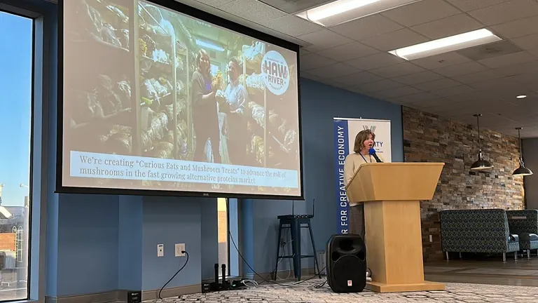Presentation slide titled ‘Haw River Mushrooms: A North Carolina Success Story in the Making’ displayed in a conference room