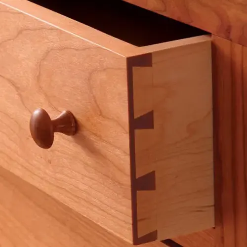 Close-up of a half-blind dovetail joint on a wooden drawer