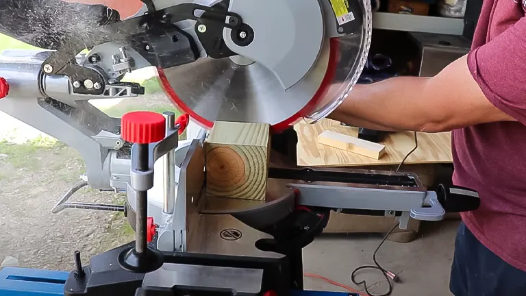 Person using ADMIRAL 12" Dual Bevel Sliding Compound Miter Saw to cut wood.