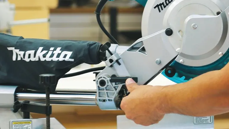Blue and silver Makita LS1018 10” Dual Slide Compound Miter Saw in use in a workshop