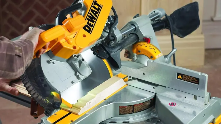 DeWalt DWS779 Double-Bevel Sliding Compound Miter Saw in use on a piece of wood.