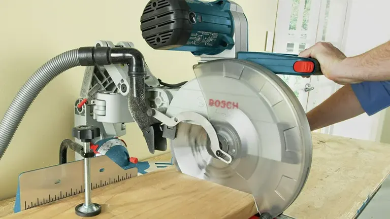 BOSCH GCM12SD 12" Dual-Bevel Sliding Glide Miter Saw in use on wooden surface.