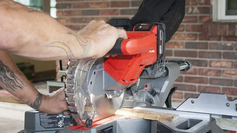 Person using a Milwaukee 2733-20 M18 FUEL 7-1/4-Inch Dual Bevel Sliding Compound Miter Saw