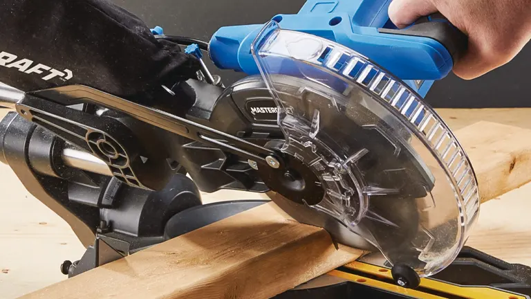 Mastercraft MS185 7-1/4 in Single-Bevel Sliding Compound Miter Saw cutting a wooden plank on a yellow workbench