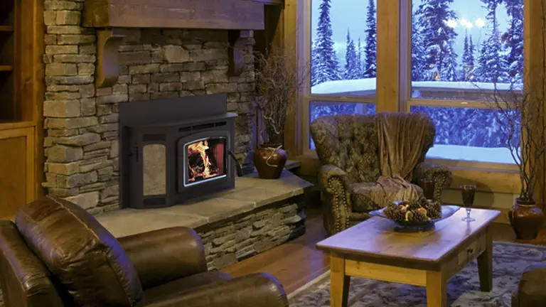 Cozy living room with a fireplace and a view of the snowy woods