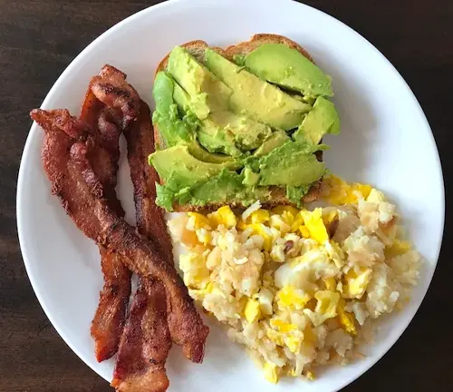Plate of Bacon Avocado toast with scrambled eggs