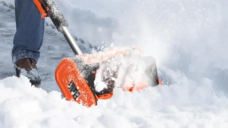 Person using MAXLANDER 20V 10-Inch Electric Battery Snow Blower on snow-covered ground