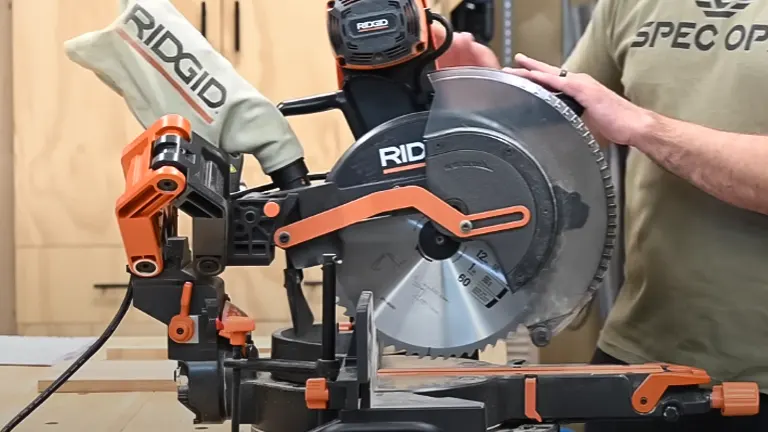 Person adjusting Ridgid R4251 12" Dual-Bevel Sliding Miter Saw in a workshop