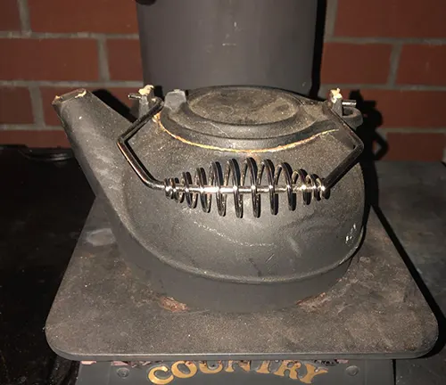 Black kettle on a soot-covered stove.
