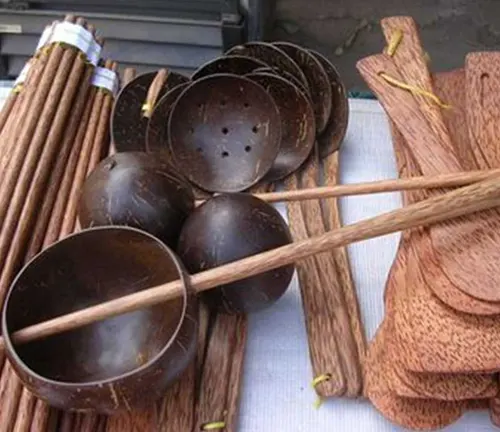 Wooden kitchen utensils and bowls on a table.