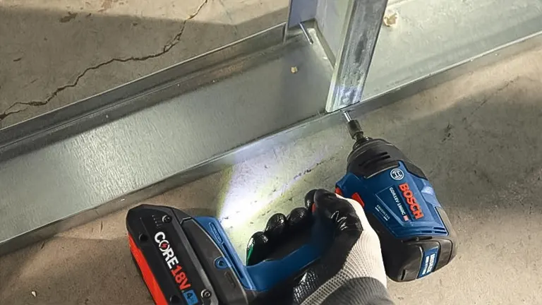 BOSCH GDR18V-1860CB25 18V Hex Impact Driver in use on a metal beam.