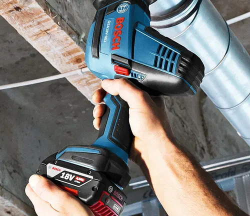 BOSCH GSA18V-083B 18V Compact Reciprocating Saw being used to cut through a pipe