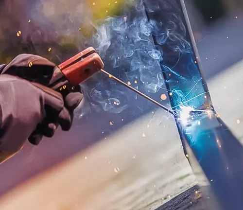 Close-up of welding process with sparks and smoke