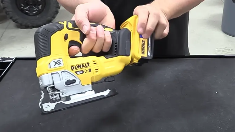 Person holding DeWalt T32331 - 20V Max XR Jigsaw Kit (5.0Ah) in workshop