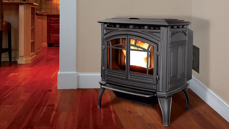 Black wood burning stove in a living room with a fire inside.