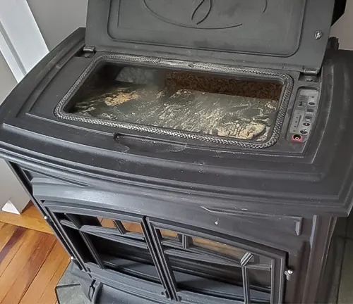 Dirty oven with a black exterior and a glass window.